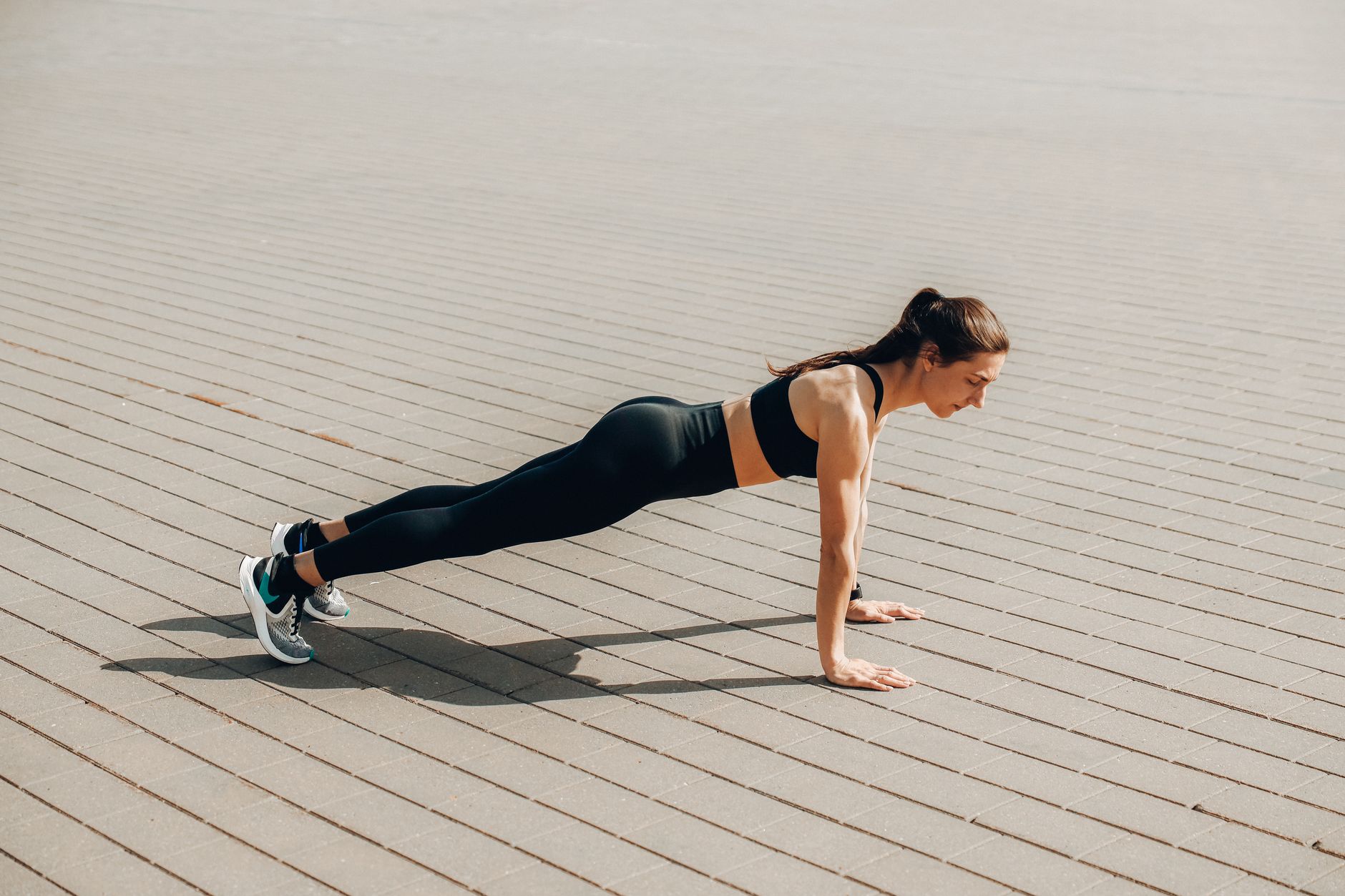 a woman in activewear doing a push up