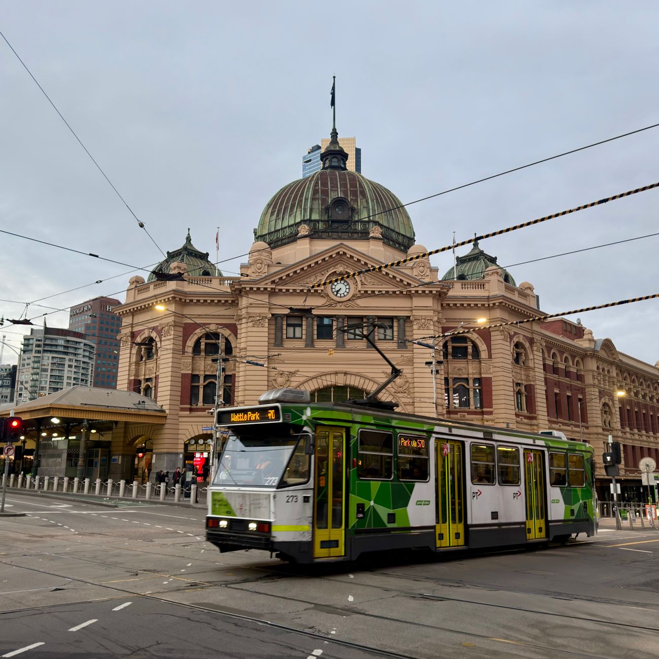 historic flinders street station in melbourne with tram